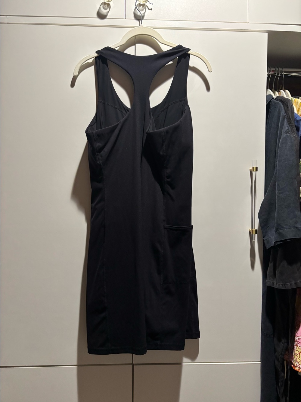 Sleek Black Racerback Mini Dress with Side Pocket